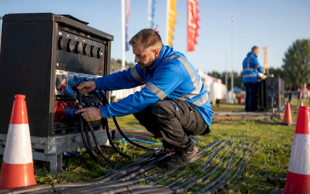 Technician inspecting outdoor event power distribution