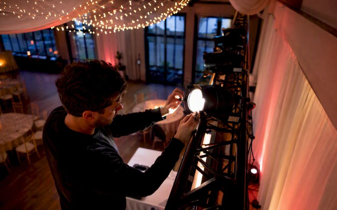 Technician adjusting event lighting at outdoor venue