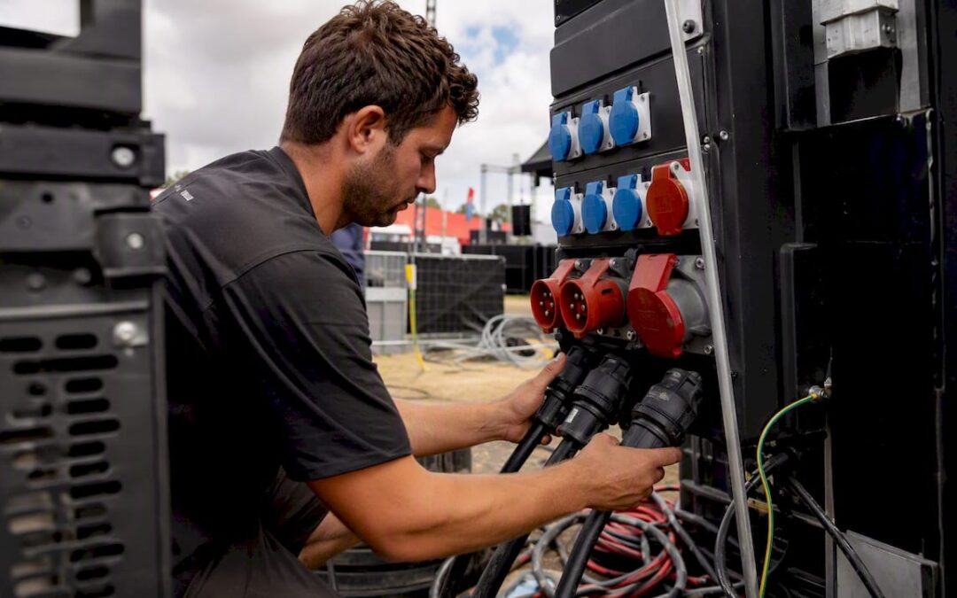 Technician adjusting power cables at event