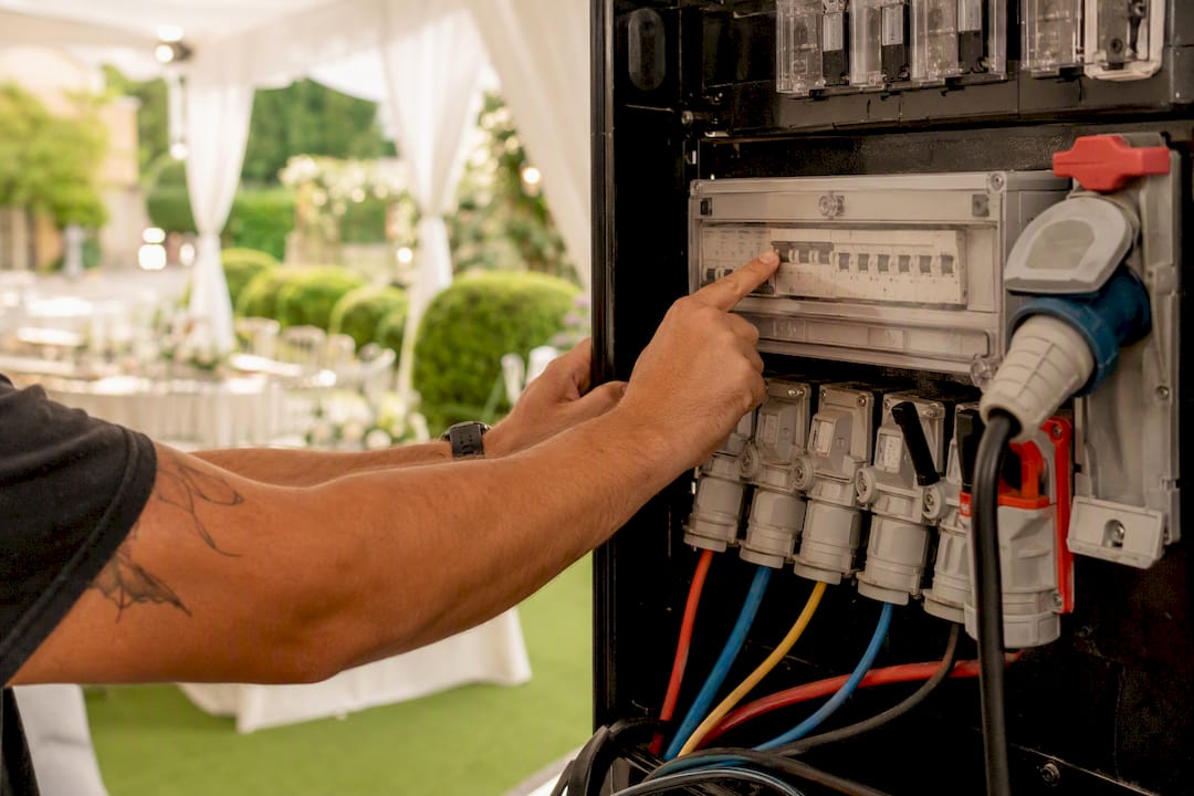 Hands testing RCD on distribution board