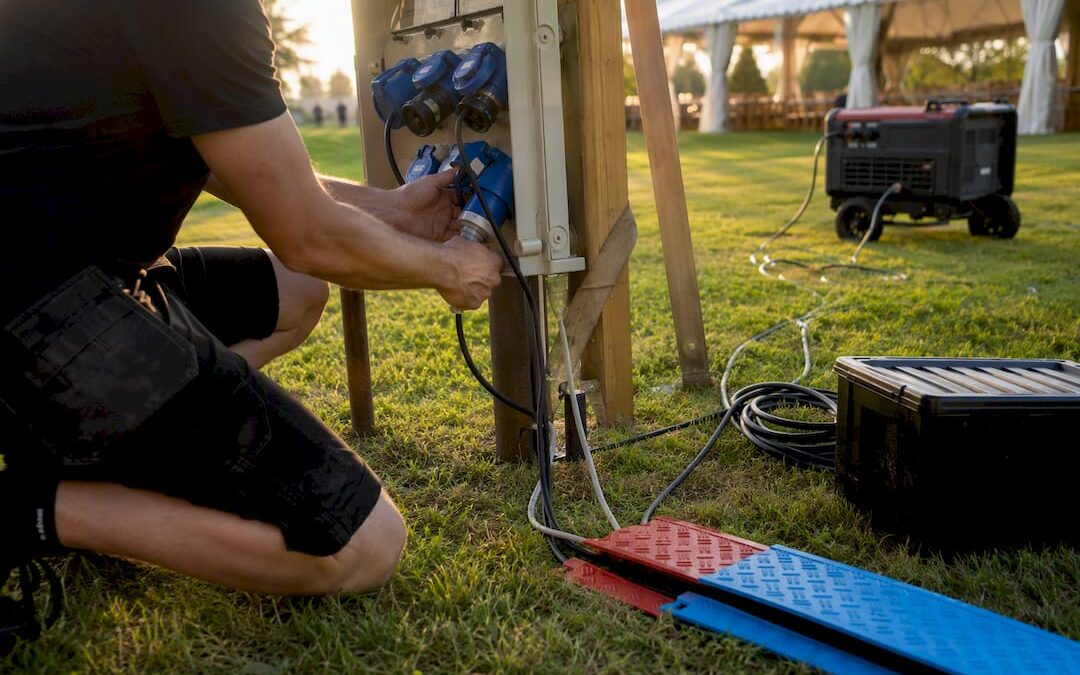Technician connecting cables to event generator