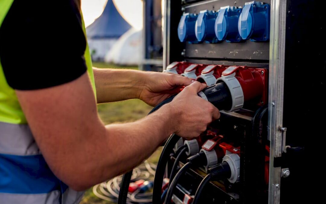 Technician connecting event power cables