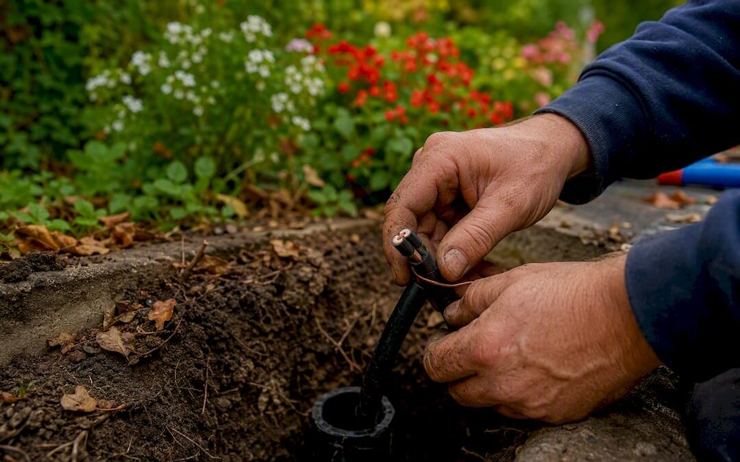 Electrician connecting mains power cable outdoors