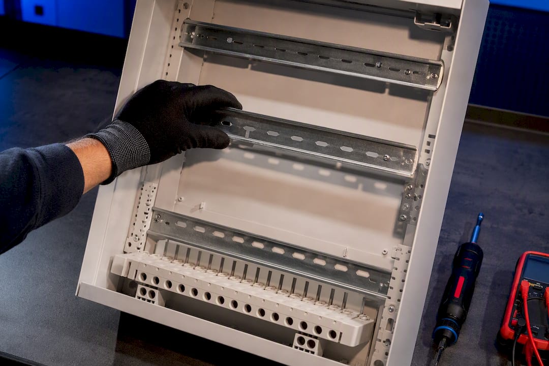 Electrician checking space inside consumer unit