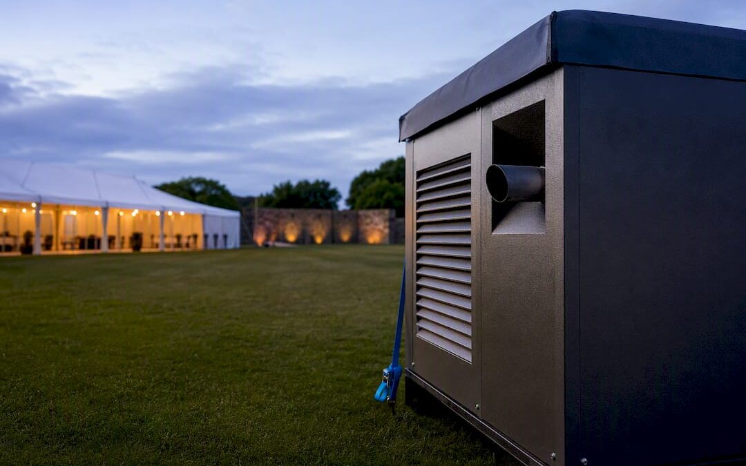 Partial acoustic enclosure beside event marquee