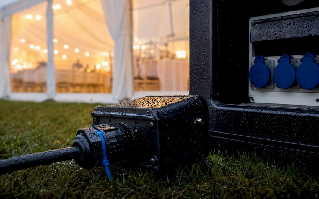 Weatherproof connector beside a wet event marquee